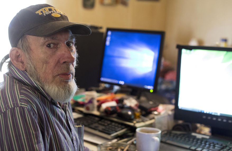 In this Tuesday, April 12, 2016 photo, James Fritz poses for a photo as he works on computers in the bedroom of his home in Elkhart, Ind. He has donated more than 400 computers to those who can’t afford them otherwise. He also helps fix and update computers for a fee. (Amanda Wilkinson/The Elkhart Truth via AP) MANDATORY CREDIT