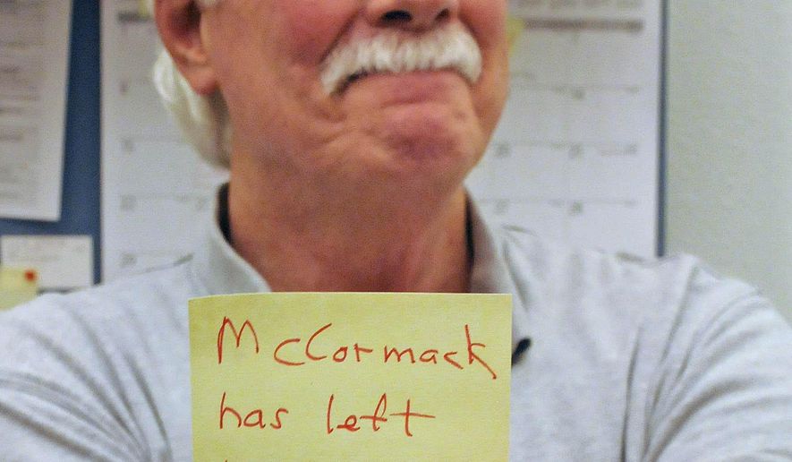 ADVANCE FOR MONDAY MAY 23 AND THEREAFTER - In a May 6, 2016 photo,Bismarck State College Professor of history Mike McCormack holds a note indicating he will retire at the end of the academic year and leave the campus after 50 years of teaching at the college. (Tom Stromme/The Bismarck Tribune via AP)