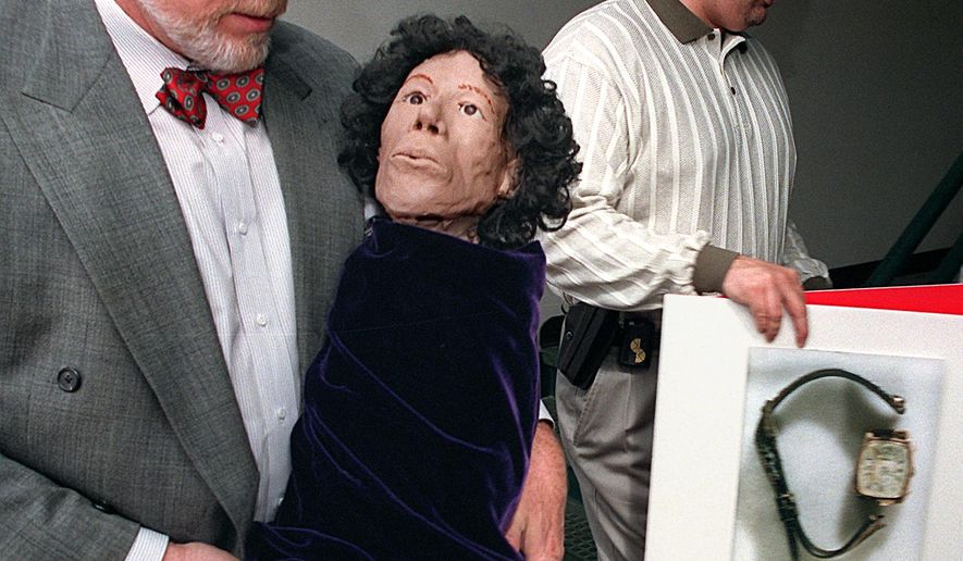 ADVANCE FOR THE WEEKEND OF MAY 21-22 AND THEREAFTER - In a March 19, 1997 photo, Dauphin County coroner Graham Hetrick and Swatara Township Det. Christopher Everett, carry facial reconstruction made from the skull of a recovered body, and an enlarged photo of watch worn by the unidentified young women, at the Swatara Twp. building. Joseph "Joey" Miller, a former Steelton man convicted in the deaths of two women, is now charged in the Swatara Township cold case homicide. For more than two decades, people have been trying to get inside the mind of convicted Steelton, Pa., serial killer Joseph D. "Joey" Miller. If the allegations are true, Joseph Miller stands, at 5 feet, 9 inches, as the midstate's most prolific killer ever. (Gary Dwight Miller/PennLive.com via AP)