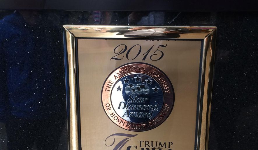 In this May 3, 2016 photo, a plaque awarding the Trump Grill five stars by the American Academy of Hospitality Sciences is seen displayed in the Trump Towers in New York. Joseph Cinque, a longtime friend of developer and presidential candidate Donald Trump, has run American Academy of Hospitality Sciences for years. A review by The Associated Press shows that more than a dozen of its board trustees are Trump friends, relatives or business associates. (AP Photo/Jeff Horwitz)