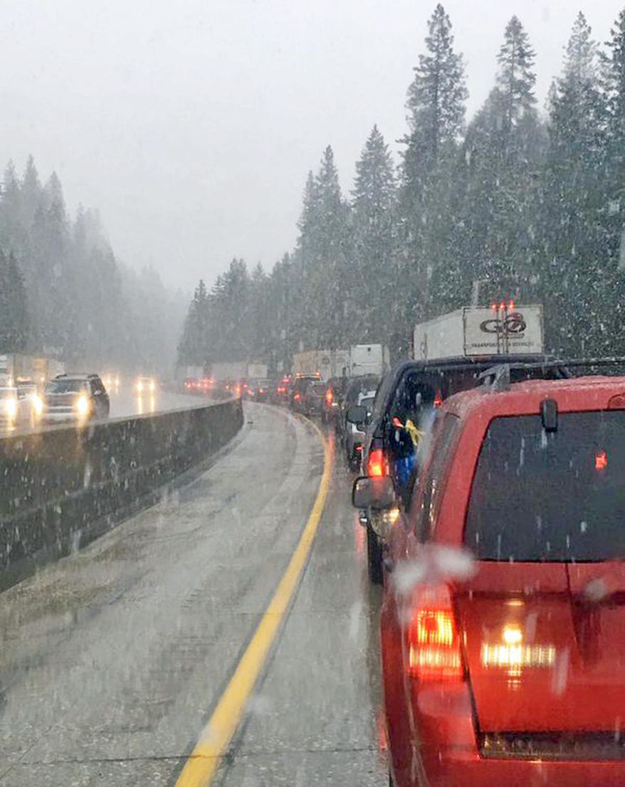 This photo provided by KTXL-TV shows traffic at a standstill on Interstate 80 at Drum Forebay near the town of Alta in the Sierra Nevada of Northern California. A late spring storm with snow at higher elevations and heavy rain elsewhere caused a rash of accidents and off-and-on closures of the main road between Sacramento and Reno, Nev. (KTXL-TV via AP) TV OUT MANDATORY CREDIT