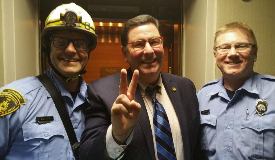 This photo provided by Pittsburgh Mayor Bill Peduto on Thursday, May 19, 2016 shows Peduto posing with two paramedics in Pittsburgh. Peduto got stuck in the Westin Hotel elevator Thursday evening along with the mayors of Millvale and Leetsdale. They had been attending a meeting of the Allegheny League of Municipalities. It wasn't clear how they'd get out because none of the mayors, and a couple others stuck along with them, could get cellphone service. One of the stranded passengers worked at the hotel and was able to summon maintenance crews and first responders using a walkie-talkie.(Pittsburgh Mayor Bill Peduto via AP)