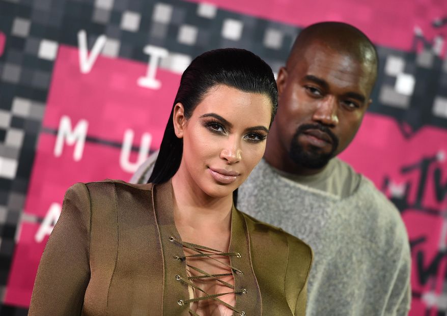 FILE - In this Aug. 30, 2015, file photo, Kim Kardashian, left, and Kanye West arrive at the MTV Video Music Awards at the Microsoft Theater in Los Angeles. Kardashian praised her husband's May 19, 2016, appearance on "The Ellen DeGeneres Show" on Twitter. (Photo by Jordan Strauss/Invision/AP, File)