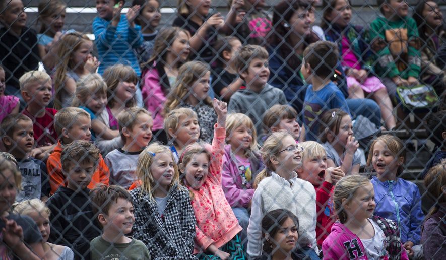 In this Thursday, May 19, 2016 photo, Priest River Elementary students cheer during the launching of a rocket during the 25th anniversary celebration of 5th grade teacher Chris Naccarato's NASA Aerospace Program in Priest River, Idaho. (Kathy Plonka/The Spokesman-Review via AP) MANDATORY CREDIT
