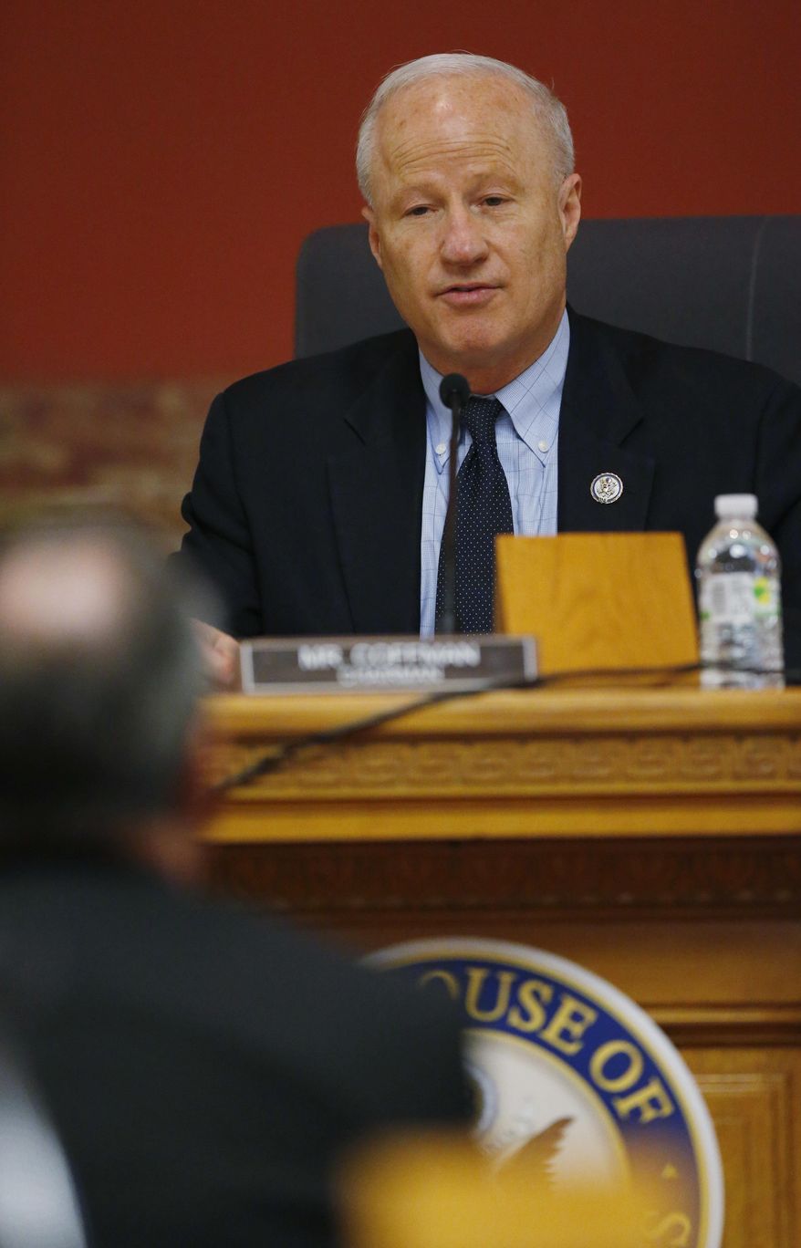 U.S. Rep. Mike Coffman,R-Colo , back, directs a question to a witness during a House Veterans Affairs subcommittee field hearing on VA hospitals and prescription drugs for veterans Friday, May 20, 2016, in the State Capitol in Denver. The House subcommittee heard from three Colorado-based VA officials during the field hearing. (AP Photo/David Zalubowski)