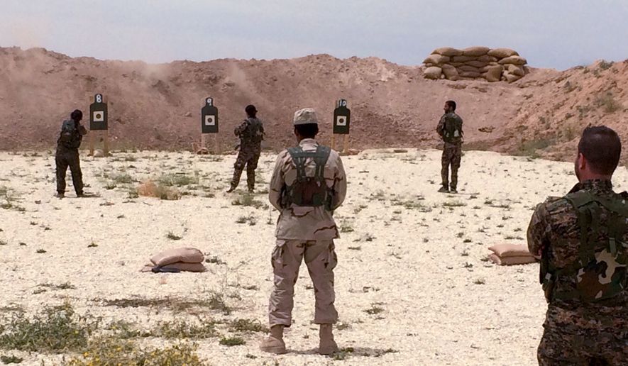 Syrian Arab trainees practice firing their small arms at an undisclosed training range in northern Syria on Saturday, May 21, 2016.  Army Gen. Joseph Votel, the top U.S. commander for the Middle East has secretly visited Syria for a first-hand look at efforts to build cohesive alliances of Arab, Kurd and other local fighters to defeat the Islamic State.  (AP Photo/Robert Burns)