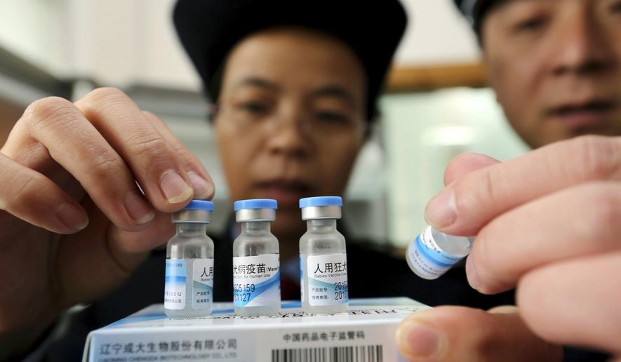 FILE - In this Monday, March 21, 2016 file photo, officials from China's State Food and Drug Administration inspect vaccines stored at the local Center for Disease Control and Prevention office in Rong'an county in southwestern China's Guangxi Zhuang Autonomous Region. China's national prosecuting office said Friday, May 20, 2016 that 135 people in 22 provinces have been arrested for illegally buying and selling vaccines, in one of the latest scandals that has shaken the public confidence in the safety of vaccines. (Chinatopix via AP, File) CHINA OUT