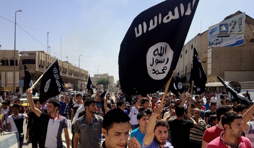 Demonstrators chant pro-Islamic State group slogans as they wave the group&#x27;s flags in front of the provincial government headquarters in Mosul, Iraq, on June 16, 2014. (Associated Press) ** FILE **