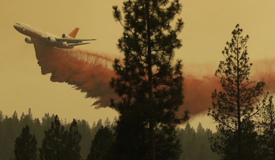 FILE - In this Aug. 27, 2015 file photo, an airplane tanker flies through smoky air as it drops fire retardant on a wildfire near Omak, Wash. Washington's 2016 wildfire season got off to an abrupt and early start in May when two separate blazes tore through dry, steep forest less than 70 miles from Seattle. Officials said the recent blazes underscore a new reality in fire-prone states like Washington _ that wildfires are happening earlier in the year, and people should be prepared. (AP Photo/Ted S. Warren, file)