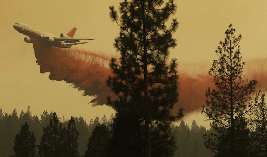 FILE - In this Aug. 27, 2015 file photo, an airplane tanker flies through smoky air as it drops fire retardant on a wildfire near Omak, Wash. Washington's 2016 wildfire season got off to an abrupt and early start in May when two separate blazes tore through dry, steep forest less than 70 miles from Seattle. Officials said the recent blazes underscore a new reality in fire-prone states like Washington _ that wildfires are happening earlier in the year, and people should be prepared. (AP Photo/Ted S. Warren, file)