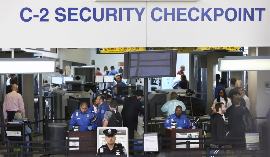 Transportation Security Administration agents work at a security checkpoint in terminal C at Newark Liberty International airport Monday, May 23, 2016, in Newark, N.J. Earlier Monday, it was announced that the TSA is adding over 100 more agents by next month. (AP Photo/Mel Evans)