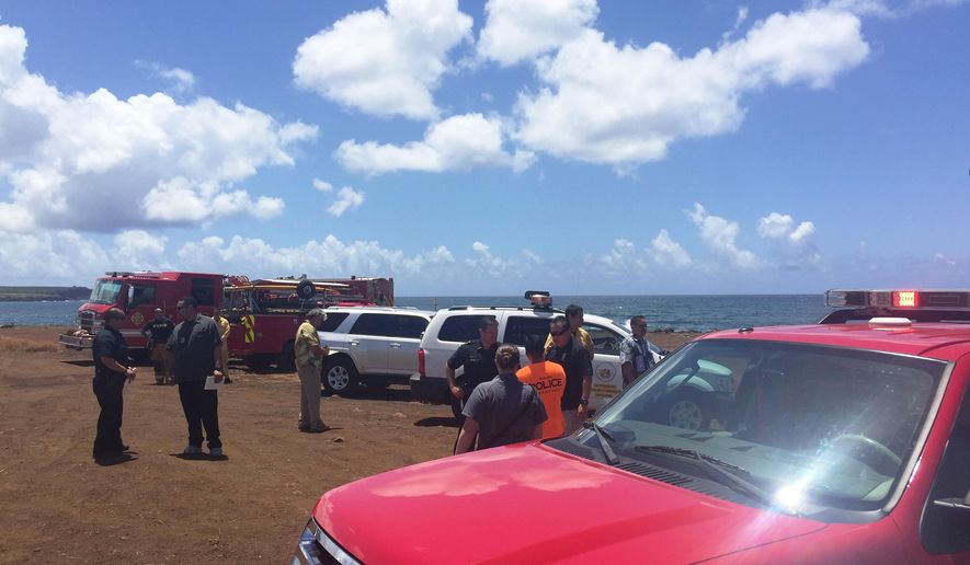 This photo provided by Kauai County shows emergency response vehicles near the site of a plane crash in Hanapepe, Hawaii, on Monday, May 23, 2016. All five people aboard a small plane died in a fiery crash on Kauai, officials said. (Sarah Blane/Kauai County via AP)