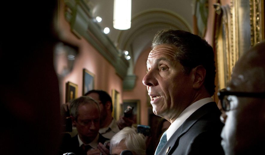 New York Gov. Andrew Cuomo talks to media members outside his office at the state Capitol on Tuesday, May 24, 2016, in Albany, N.Y. Cuomo says tightening campaign finance laws and fighting the heroin epidemic are two of his top priorities as lawmakers near adjournment. (AP Photo/Mike Groll)