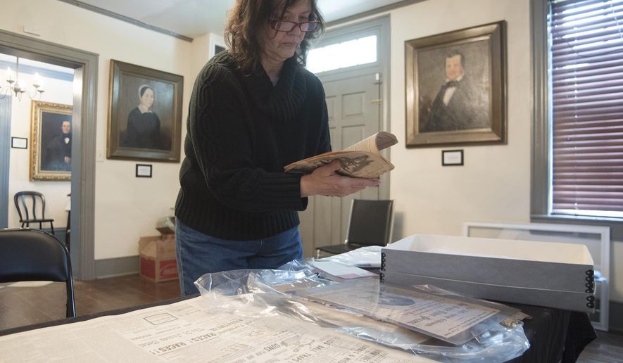 In a May 3, 2016 photo, Christine Buckelew, president of the Fayette County Historical Society, prepares for the latest museum exhibition on the infamous Nutt murder case from the 1800's in Uniontown, Pa. The story is being retold at the historical society in a new exhibit called "An American Tragedy" at the Abel Colley Tavern and Museum, located in Menallen Township on Route 40. (Rebecca Devereaux /Herald-Standard via AP) MANDATORY CREDIT (REV-SHARE)