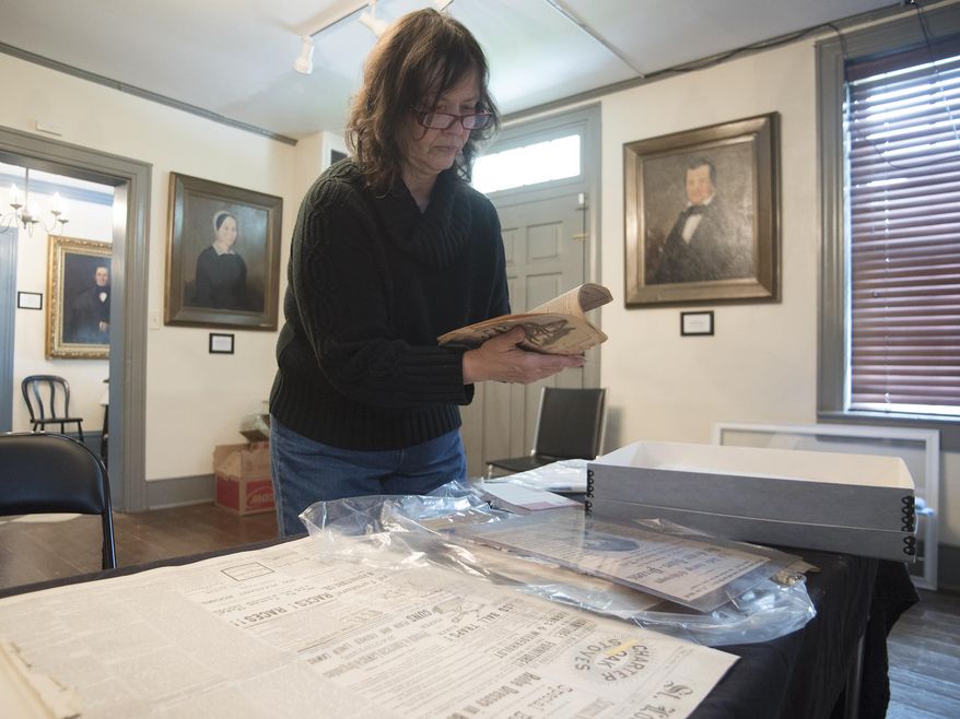 In a May 3, 2016 photo, Christine Buckelew, president of the Fayette County Historical Society, prepares for the latest museum exhibition on the infamous Nutt murder case from the 1800's in Uniontown, Pa. The story is being retold at the historical society in a new exhibit called "An American Tragedy" at the Abel Colley Tavern and Museum, located in Menallen Township on Route 40. (Rebecca Devereaux /Herald-Standard via AP) MANDATORY CREDIT (REV-SHARE)