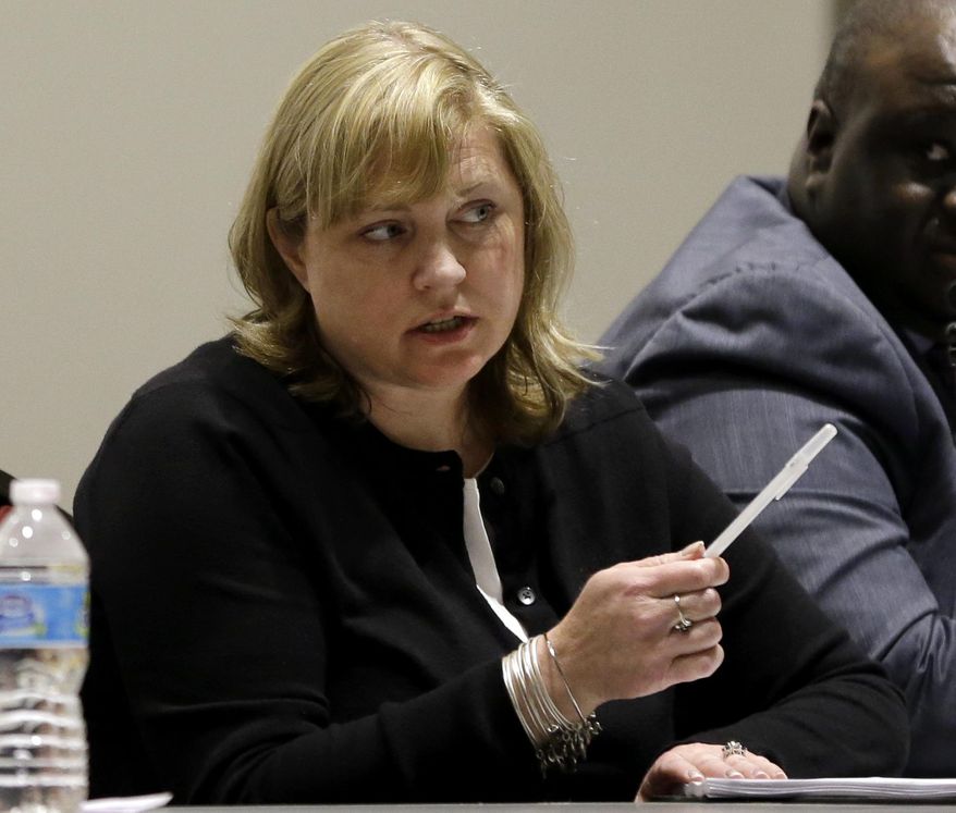 In this March 15, 2016 photo, Ferguson city attorney Stephanie Karr participates in a city council meeting in Ferguson, Mo. Karr, who had been criticized by the federal investigation of Ferguson's justice system after the police shooting death of Michael Brown, announced her resignation as Ferguson city attorney Monday, May 23, 2016, just weeks after the city announced they were removing her as local prosecutor a position she also held. (AP Photo/Jeff Roberson)