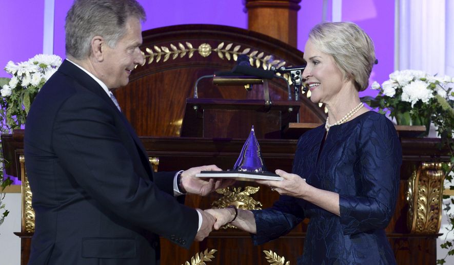 US biochemical engineer Frances Arnold, right, receives her Millennium Technology Prize 2016 from Finnish President Sauli Niinisto at the awards ceremony in Helsinki, Finland, on Tuesday, May 24, 2016. Arnold has won this year's $1.2 million Millennium Technology Prize for discoveries in "directed evolution," which has helped sustainable development and clean technology become available in many areas of industry. (Heikki Saukkomaa/Lehtikuva via AP) FINLAND OUT