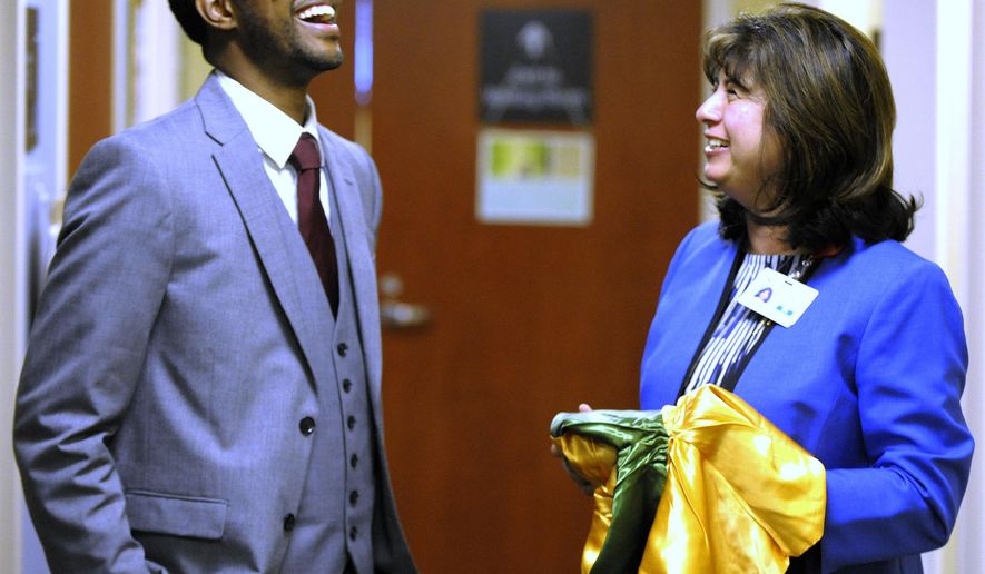 FILE - In this May 4, 2016 file photo, Kevin Morton meets with Beaumont Hospital Grosse Pointe Dr. Dharti Sheth-Zelmanski, to drop off a cap, gown and hood for the doctor in Grosse Point, Mich. Morton has graduated from Michigan State University's College of Osteopathic Medicine and was inspired to become a surgeon by Detroit doctors, including Dr. Sheth-Zepmanski, who saved his life when he was shot on Detroit's eastside almost nine years ago. (Todd McInturf/The Detroit News via AP)
