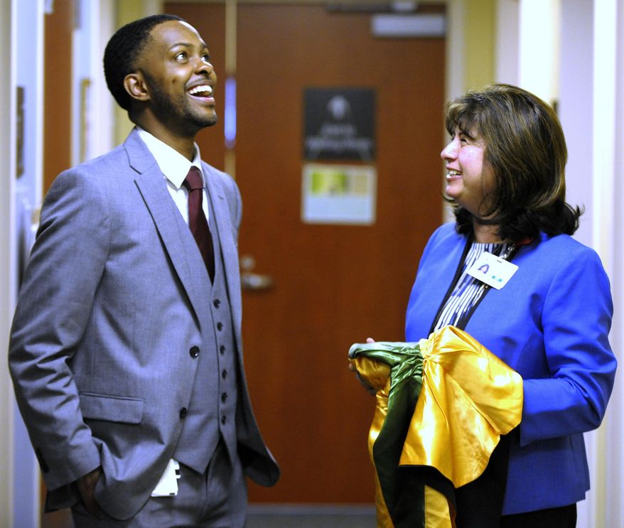 FILE - In this May 4, 2016 file photo, Kevin Morton meets with Beaumont Hospital Grosse Pointe Dr. Dharti Sheth-Zelmanski, to drop off a cap, gown and hood for the doctor in Grosse Point, Mich. Morton has graduated from Michigan State University's College of Osteopathic Medicine and was inspired to become a surgeon by Detroit doctors, including Dr. Sheth-Zepmanski, who saved his life when he was shot on Detroit's eastside almost nine years ago. (Todd McInturf/The Detroit News via AP)