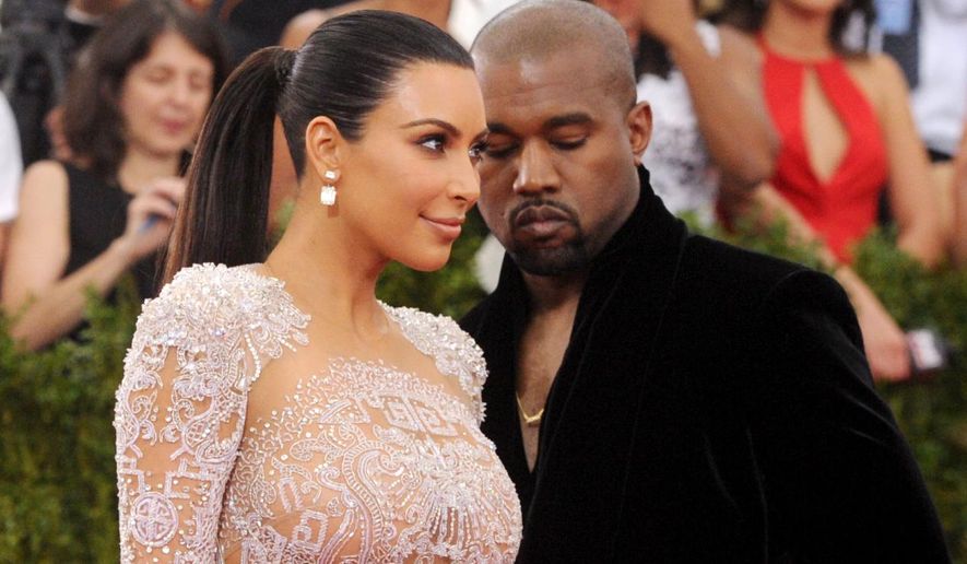 FILE - In this May 4, 2015, file photo, Kim Kardashian, left, and Kanye West arrive at The Metropolitan Museum of Art's Costume Institute benefit gala in New York. Kardashian posted a tribute to West on Instagram to mark the couple's second wedding anniversary on May 24, 2016. (Photo by Charles Sykes/Invision/AP, File)