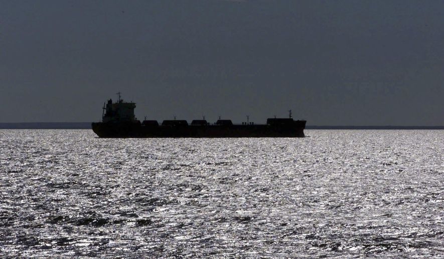 FILE -- In this July of 1999 file photo, a freighter is silhouetted in Lake Superior near Whitefish Point, Mich. A plan gaining support in Congress and backed by the cargo shipping industry would establish a nationwide policy for treating ballast water dumped from cargo ships into U.S. waterways. Environmental groups say that would open the door to more invasive species like zebra and quagga mussels, which have wreaked havoc from the Great Lakes to the West Coast. (AP Photo/Carlos Osorio)