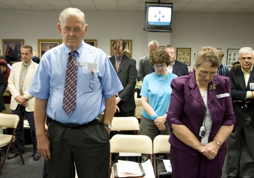 FILE - In this Sept. 24, 2010 file photo, Anthony Bruner and Mary Lou Bruner, right, pray at the start of a meeting of the Texas State Board of Education to discuss Islam and Christianity in textbooks in Austin, Texas. Mary Lou Bruner, a retired Texas schoolteacher who claims President Barack Obama is a gay prostitute is the Republican front-runner in a primary runoff for a seat on the influential state education board. Bruner is back on the ballot Tuesday, May 24, 2016, after nearly clinching the Republican nomination outright in March. (Jay Janner/Austin American-Statesman via AP, File) AUSTIN CHRONICLE OUT, COMMUNITY IMPACT OUT, INTERNET AND TV MUST CREDIT PHOTOGRAPHER AND STATESMAN.COM, MAGS OUT; MANDATORY CREDIT