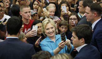 Democratic presidential candidate Hillary Clinton poses for selfies at a rally at the University of California, Riverside, Tuesday, May 24, 2016, in Riverside, Calif. (AP Photo/John Locher)