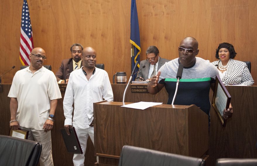 Kevin Saunderson, right, gives a short speech as he and fellow Detroit techno music pioneers, from left, Eddie Fowlkes and Juan Atkins were honored by the Detroit City Council on Tuesday, May 24 , 2016, in Detroit. The Council presented Testimonial Resolutions and Spirit of Detroit Awards to the following individuals and organizations: Atkins, Derrick May, Saunderson, Fowlkes, John Collins, Underground Resistance and the Submerge Techno Museum, Movement Electronic Music Festival, Kelli Hand, Carl Craig, Jeff Mills, and Paxahau Events. (John T. Greilick/Detroit News via AP) DETROIT FREE PRESS OUT; HUFFINGTON POST OUT; MANDATORY CREDIT