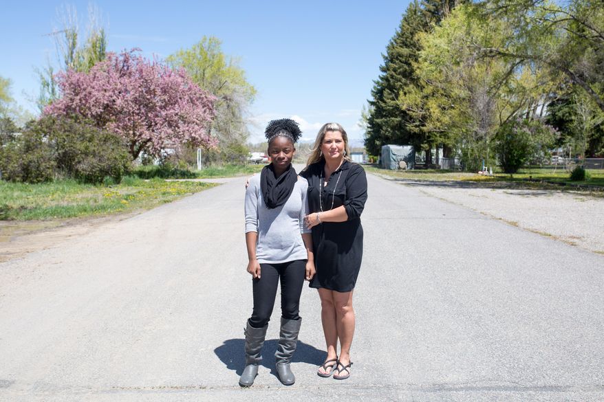 ADVANCE FOR WEEKEND EDITIONS, MAY 28-31 - In this photo taken Wednesday, May 18, 2016, Heather Pasquinelli and her daughter, Gabrielle, stand for a portrait in Pavillion, Wyo. Pasquinelli recently left her job teaching at Wind River Middle School following a series of racially charged incidents, and what she considered an inadequate response from the administration. (Jenna VonHofe/The Casper Star-Tribune via AP) MANDATORY CREDIT