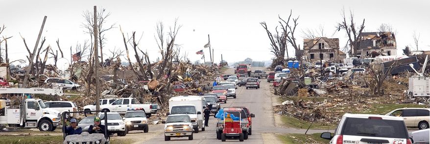 This May 25, 2008 photo shows damage to a neighborhood, west along Highway 57 in Parkersburg, Iowa after an EF5 tornado passed through the town. It's been eight years since a massive tornado destroyed nearly 300 homes and killed nine people in Parkersburg, and city leaders say the northern Iowa town's revival is a model for other communities recovering from natural disasters. (Rick Chase/The Courier via AP) MANDATORY CREDIT