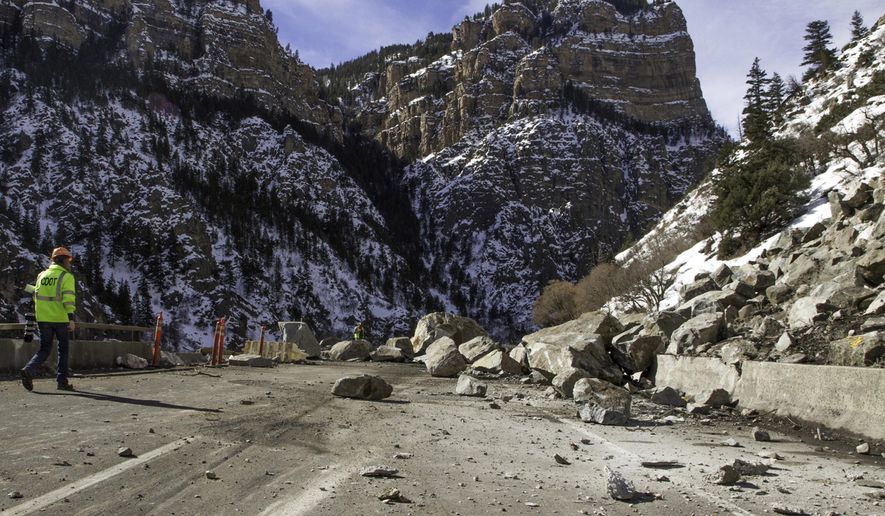 ADVANCE FOR SATURDAY, MAY 28- FILE - In this Wednesday, Feb. 17, 2016, file photograph, a Colorado Department of Transportation worker examines debris from a rock slide on Interstate 70 in Glenwood Canyon east of Glenwood Springs, Colo. All lanes of the interstate were reopened Wednesday, April 13, 2016, after the emergency work, which tallied $5 million, was completed 23 days ahead of schedule. The Glenwood Post-Independent has analyzed data from the state transportation department that shows Interstate 70 closes an average of every 2.4 days west of Denver. (Chelsea Self/Glenwood Springs Post Independent via AP, file) MANDATORY CREDIT