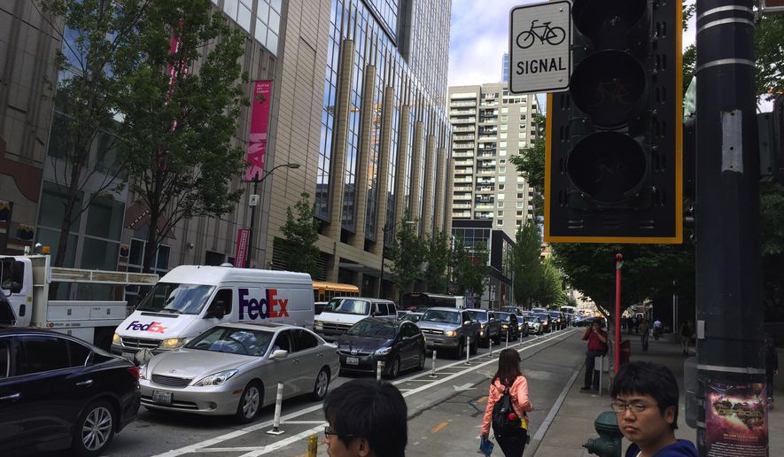Traffic backs up at the intersection of Second Avenue and University Street due to a power outage, on Wednesday, May 25, 2016 in Seattle. A Seattle utility spokesman says an equipment failure at a substation darkened much of Seattle’s downtown core for about an hour. (Alan Berner/The Seattle Times via AP) SEATTLE OUT; USA TODAY OUT; MAGS OUT; TELEVISION OUT; NO SALES; MANDATORY CREDIT TO BOTH THE SEATTLE TIMES AND THE PHOTOGRAPHER