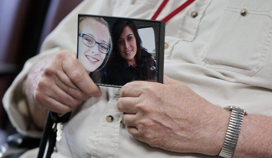 Rebekah Bletsch's father Nick Winberg clutches a photo of his daughter Rebekah with her daughter as he talks to the media about the open murder charges filed against Jeffrey Willis on Wednesday, May 25, 2016, in Muskegon, Mich. Willis, a western Michigan man accused of abducting a teenage girl last month has been charged with murder in the shooting death of Bletsch in 2014, prosecutors announced Wednesday. (Joel Bissell/Muskegon Chronicle via AP) ALL LOCAL TELEVISION OUT; LOCAL TELEVISION INTERNET OUT; MANDATORY CREDIT