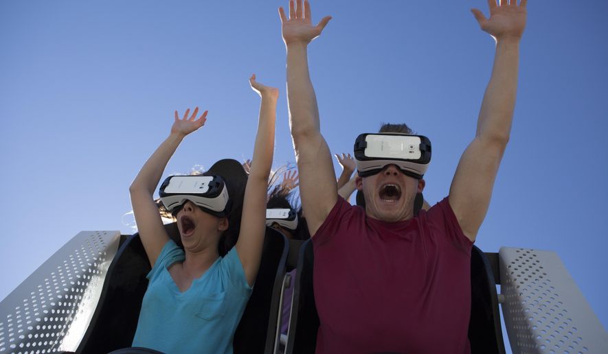 In this undated photo provided by Six Flags New England, visitors ride the new Superman The Ride Virtual Reality Coaster at the park in Agawam, Mass. (Six Flags New England via AP)