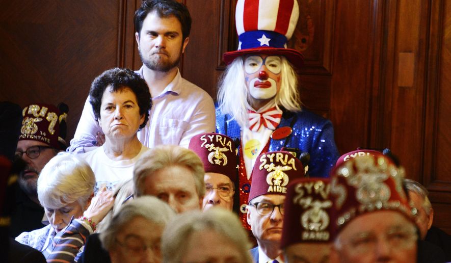 Clowns, including Jeff Cox, back, crowd the City Council chamber during a City Council hearing on a proposed wild-animal entertainment ban that would keep circuses and similar shows out of the city, Tuesday, May 24, 2016. Syria Shrine clowns also held signs outside the City-County Building begging the City Council not to enact the measure. (Darrell Sapp/Pittsburgh Post-Gazette via AP) MAGS OUT; MONESSEN OUT; KITTANNING OUT; CONNELLSVILLE OUT; GREENSBURG OUT; TARENTUM OUT; NORTH HILLS NEWS RECORD OUT; BUTLER OUT; MANDATORY CREDIT