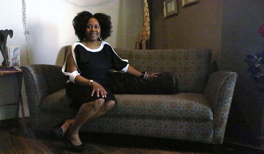 In this May 2, 2016, photo, Dr. Elisha Robinson-Asiso poses for a photo at her new business Integrative Healing Center in Rockford, Ill. Robinson-Asiso treats patients facing breast cancer or other breast health issues. She focuses on a holistic approach to treatment. (Maggie Hradecky/Rockford Register Star via AP) MANDATORY CREDIT