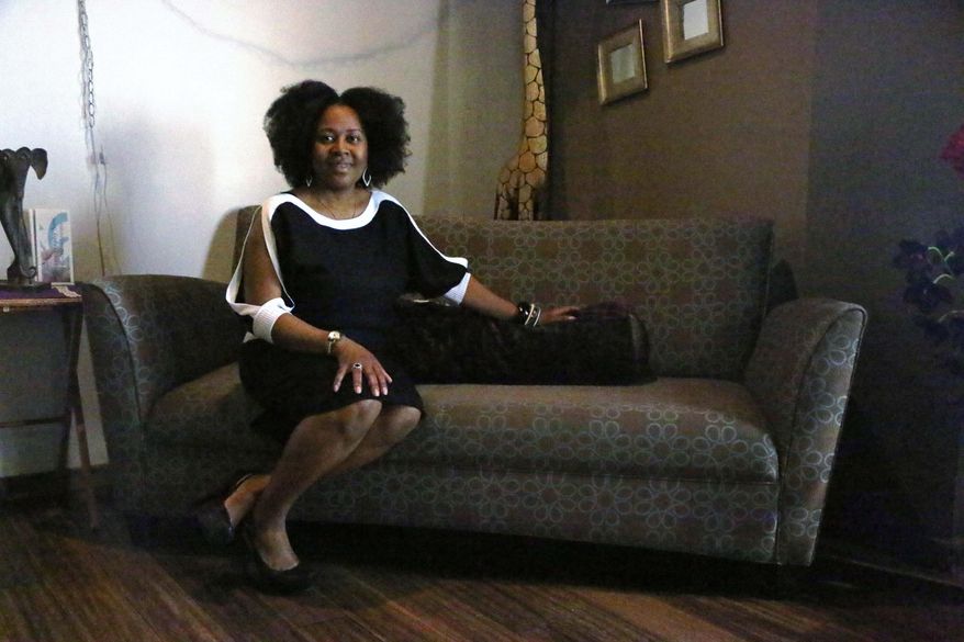 In this May 2, 2016, photo, Dr. Elisha Robinson-Asiso poses for a photo at her new business Integrative Healing Center in Rockford, Ill. Robinson-Asiso treats patients facing breast cancer or other breast health issues. She focuses on a holistic approach to treatment. (Maggie Hradecky/Rockford Register Star via AP) MANDATORY CREDIT
