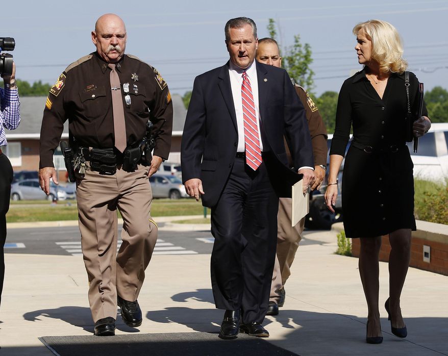 Mike Hubbard and wife Susan Hubbard walk to the Lee County Justice Center for day three of Hubbards trial trial on Thursday, May 26, 2016 in Opelika, Ala. Hubbard faces felony ethics charges accusing him of using his political positions to obtain $2.3 million in work and investments. (Todd J. Van Emst/Opelika-Auburn News via AP, Pool)