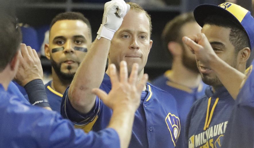 Milwaukee Brewers&#x27; Aaron Hill is congratulated after hitting a home run during the fifth inning of a baseball game against the Cincinnati Reds Friday, May 27, 2016, in Milwaukee. (AP Photo/Morry Gash)