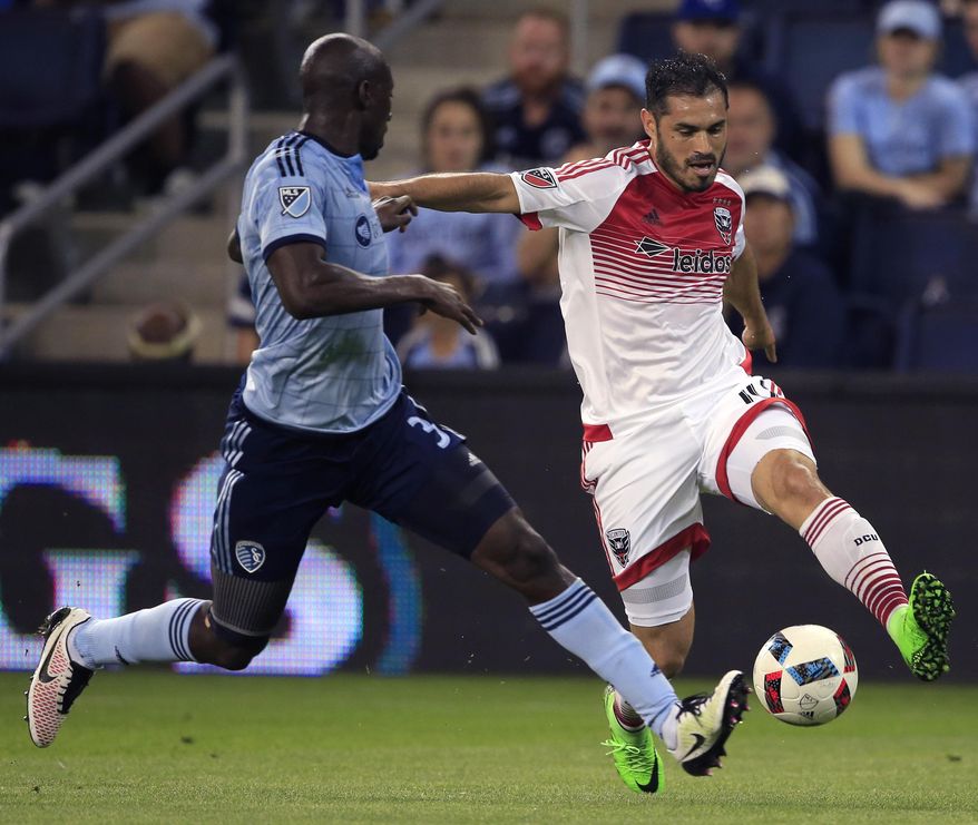 D.C. United forward Fabian Espindola, right, is challenged by Sporting Kansas City defender Ike Opara (3) during the first half of an MLS soccer match in Kansas City, Kan., Friday, May 27, 2016. (AP Photo/Orlin Wagner) **FILE**