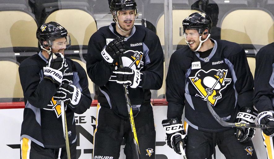 Pittsburgh Penguins&#39; Chris Kunitz, left, Evgeni Malkin (71) and Sidney Crosby (87) wait to run a drill during hockey practice at the Consol Energy Center in Pittsburgh, Sunday May 29, 2016. The Penguins are preparing for Game 1 of the Stanley Cup finals against the San Jose Sharks on Monday, May 30, in Pittsburgh. (AP Photo/Gene J. Puskar)