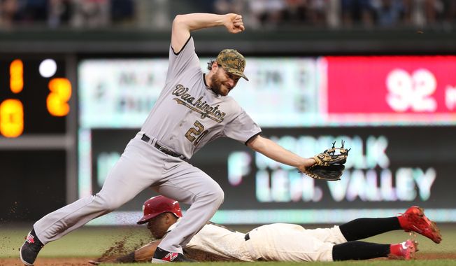 Philadelphia Phillies' Cesar Hernandez is safe on a steal at second base as Washington Nationals second baseman Daniel Murphy (20) misses the throw with with Tyler Goeddel at bat in the second inning of a baseball game, Monday, May 30, 2016, in Philadelphia. (AP Photo/Laurence Kesterson)