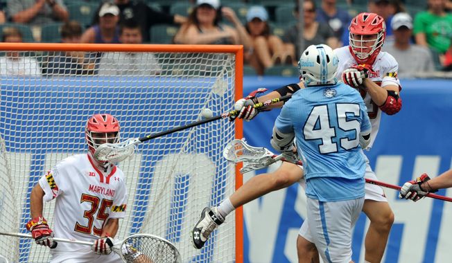 University of North Carolina&#x27;s Chris Cloutier (45) shoots and scores on University of Maryland goalie Lyle Bernlohr (35) as Maryland teammate Matt Dunn, right, also defends during the NCAA Division 1 men&#x27;s lacrosse final in Philadelphia, Monday, May 30, 2016.(Clem Murray/The Philadelphia Inquirer via AP)  PHIX OUT; TV OUT; MAGS OUT; NEWARK OUT; MANDATORY CREDIT