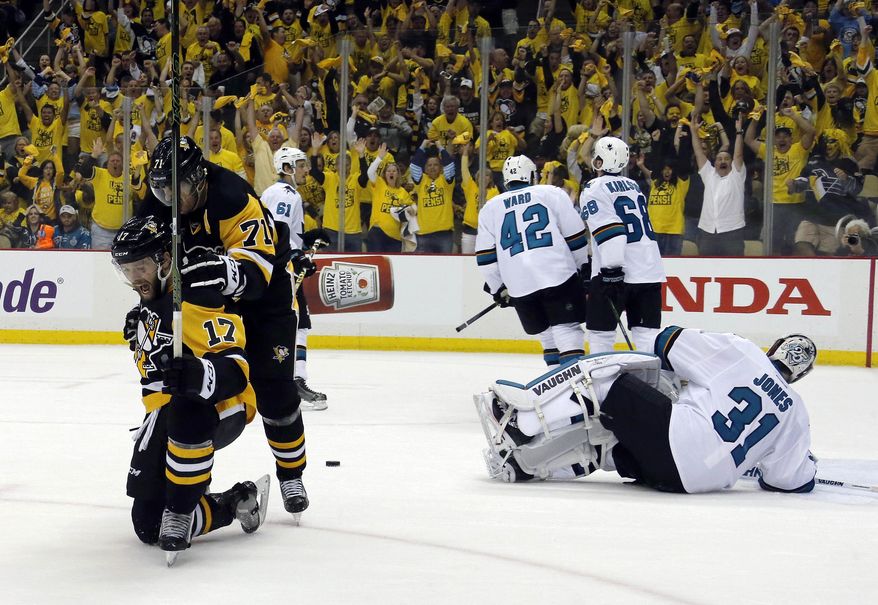 Pittsburgh Penguins' Bryan Rust (17) celebrates with Evgeni Malkin (71) his goal against San Jose Sharks goalie Martin Jones (31) during the first period in Game 1 of the Stanley Cup final series Monday, May 30, 2016, in Pittsburgh. (AP Photo/Keith Srakocic)