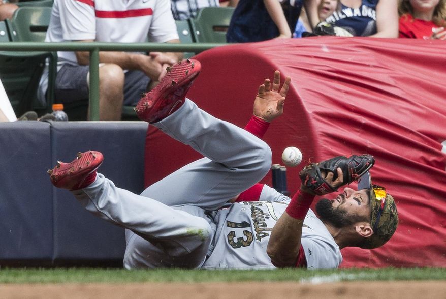 St. Louis Cardinals&#39; Matt Carpenter makes a diving attempt at a foul ball hit by Scooter Gennett during the third inning of a baseball game Monday, May 30, 2016, in Milwaukee. Carpenter was not able to make the catch on the play. (AP Photo/Tom Lynn)