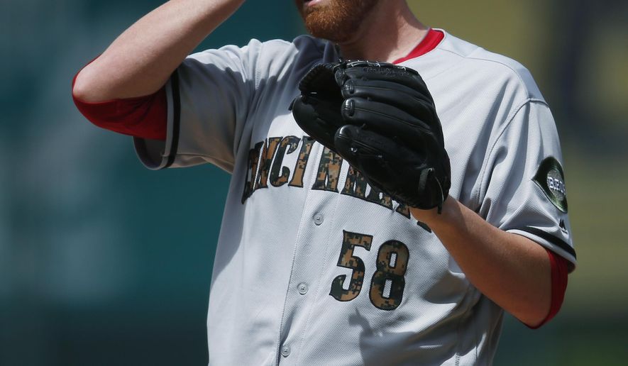 Cincinnati Reds starting pitcher Dan Straily reacts after giving up a leadoff, solo home run to Colorado Rockies Charlie Blackmon in the first inning of a baseball game Monday, May 30, 2016, in Denver. (AP Photo/David Zalubowski)