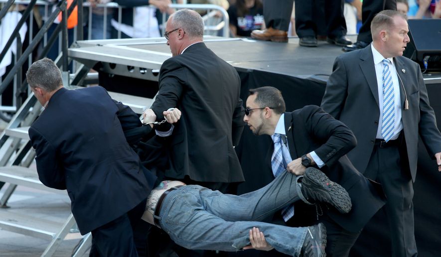 Secret Service agents remove a man from the crowd during a campaign rally for Democratic presidential candidate, Sen. Bernie Sanders, I-Vt., at Frank Ogawa Plaza in Oakland, Calif., on Monday, May 30, 2016. (Anda Chu/Oakland Tribune via AP)