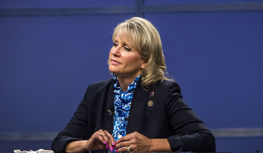 In this Thursday, May 19, 2016 photo, Rep. Renee Ellmers listens while facing off with Dr. Greg Brannon and Rep. George Holding during the 2nd Congressional District Republican primary debate at WRAL studio in Raleigh, N.C. (Travis Long/The News &amp; Observer via AP, Pool)
