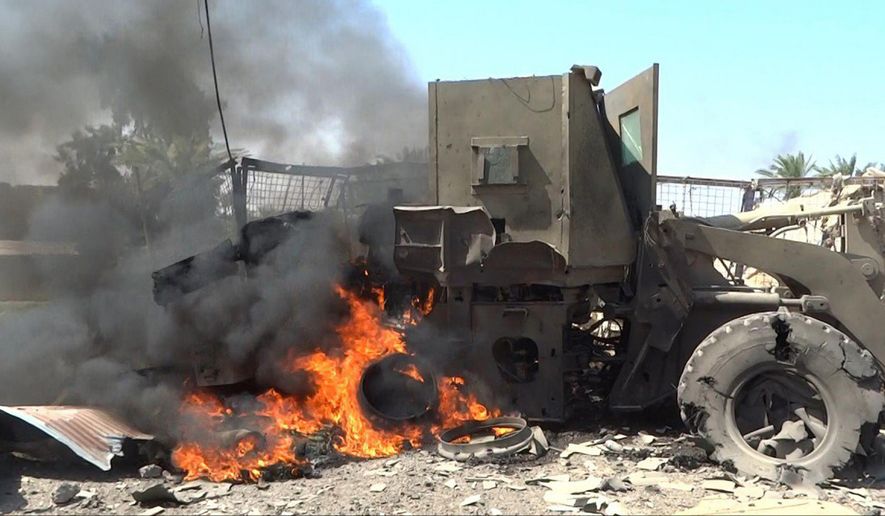 In this image posted on a photo sharing website by an Islamic State militant media arm on Monday, May 30, 2016, a military vehicle burns as ISIS fighters battle Iraqi forces and their allies west of Fallujah, Iraq. Iraqi forces battling their way into Fallujah repelled a four-hour attack by the Islamic State group in the city&#39;s south on Tuesday, a day after first moving into the southern edges of the militant-held city with the help of U.S.-led coalition airstrikes.(militant photo via AP)