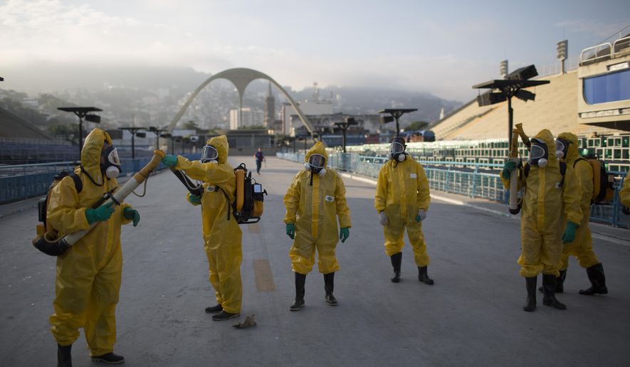 FILE - This is a  Tuesday, Jan. 26, 2016  file photo of health workers as they get ready to spray insecticide to combat the Aedes aegypti mosquitoes that transmits the Zika virus under the bleachers of the Sambadrome in Rio de Janeiro,  which will be used for the Archery competition in the 2016 summer games. With the opening ceremony just over two months away, Olympic leaders have plenty of challenges to discuss this week when they meet for the last time before gathering in Rio de Janeiro on the eve of South America’s first games. (AP Photo/Leo Correa, File)